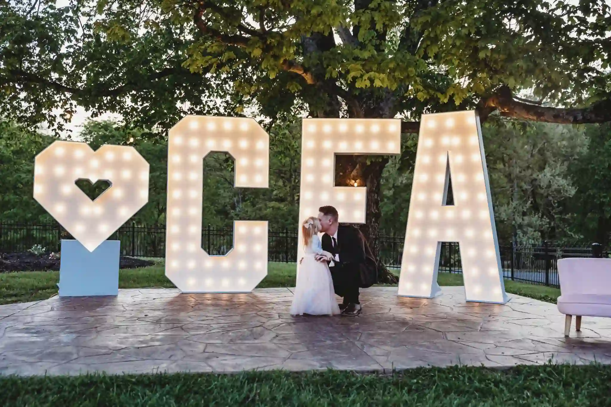 Father and daughter share moment in front of CFA marquee letters Chattanooga TN