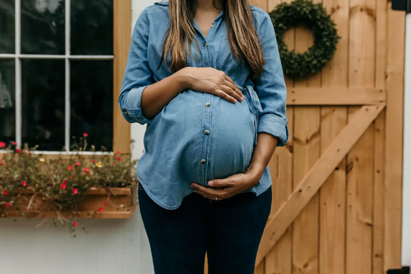 Pregnant mom standing with baby shower marquee letters