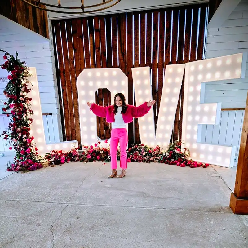 7ft LOVE marquee letters with floral rose accents and warm white wedding lighting