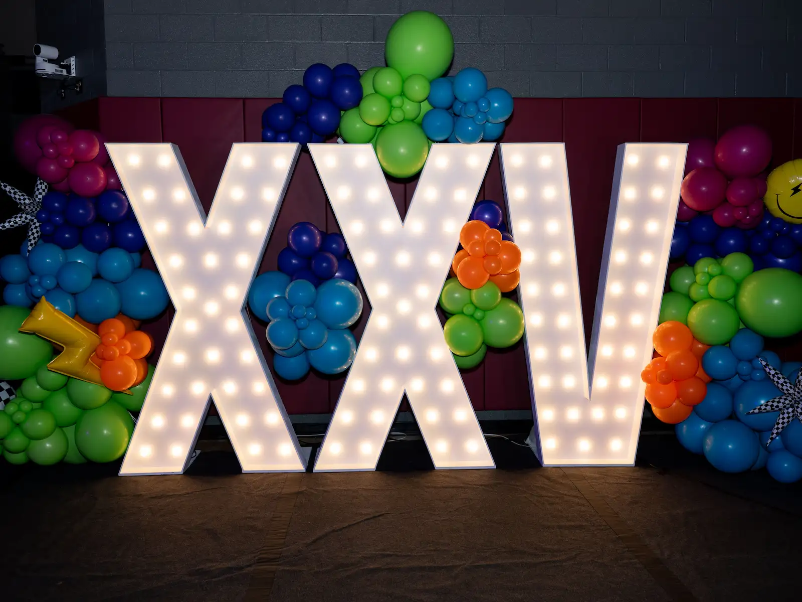 XXV prom letters made with light up marquee letters and balloon school dance decorations