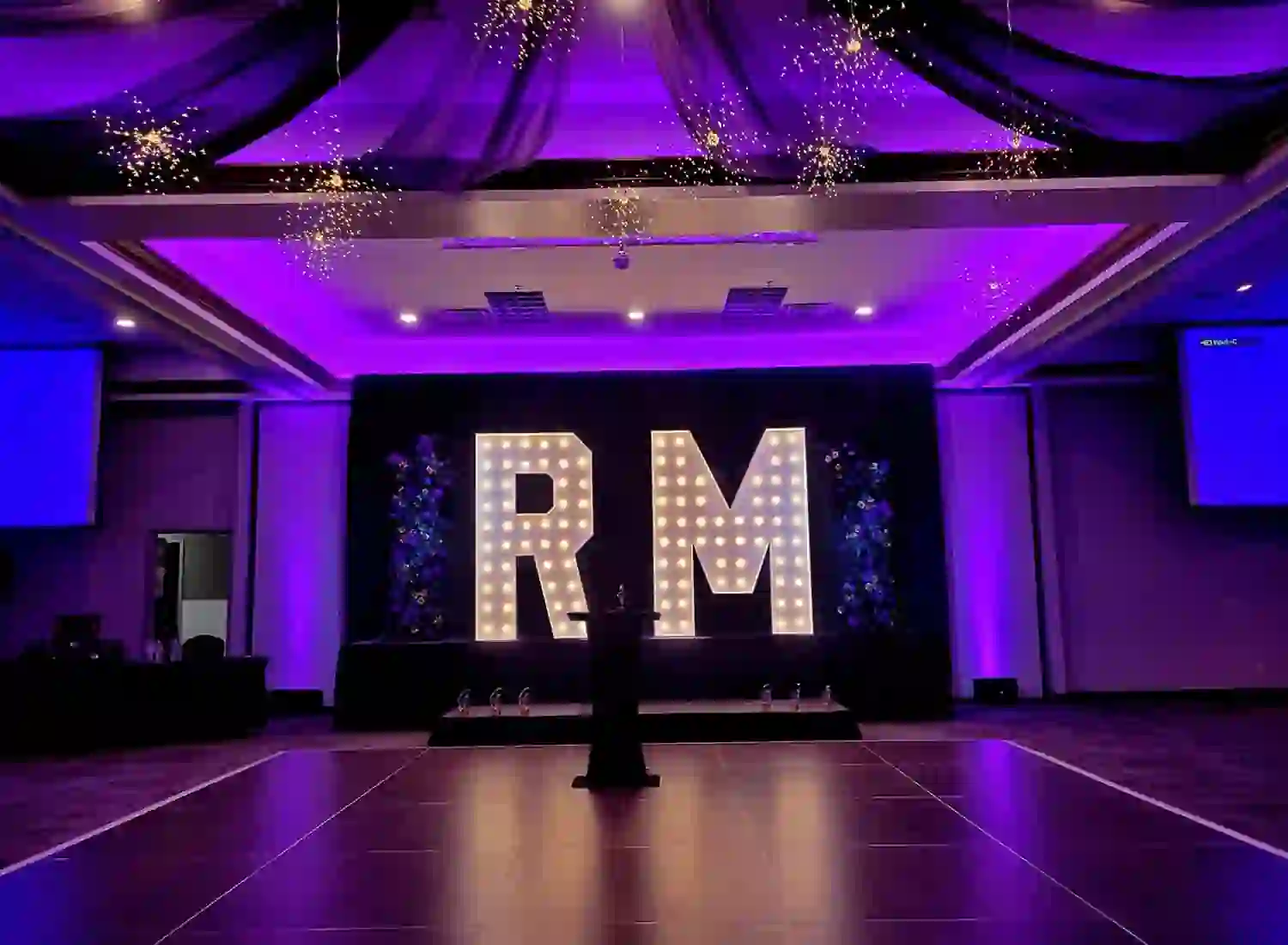 RM corporate event marquee letters on stage with uplighting in Nashville, TN