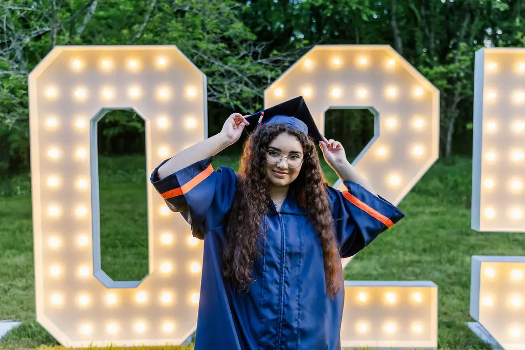 2026 graduation marquee letters with graduate and balloons
