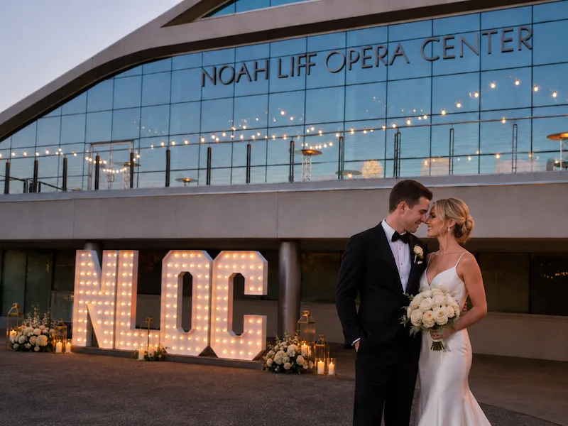 Bride and groom posing with 7-foot marquee letters at Noah Liff Opera Center in Nashville