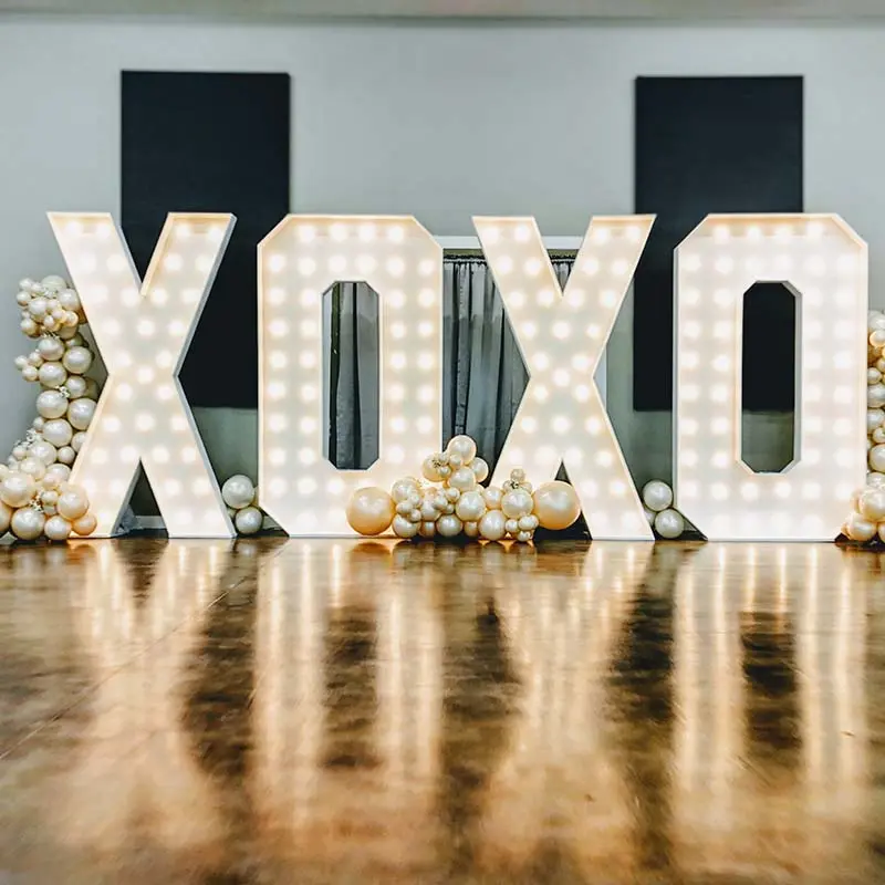 7ft XOXO marquee letters with white balloons at a wedding celebration